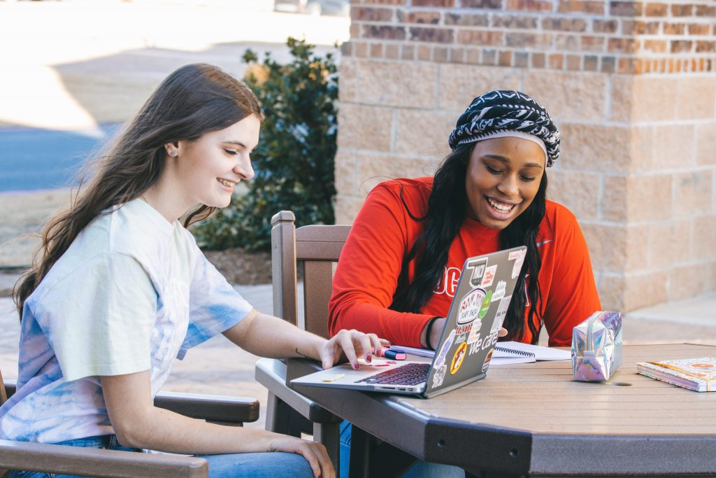 Two girls outside in front of dorms