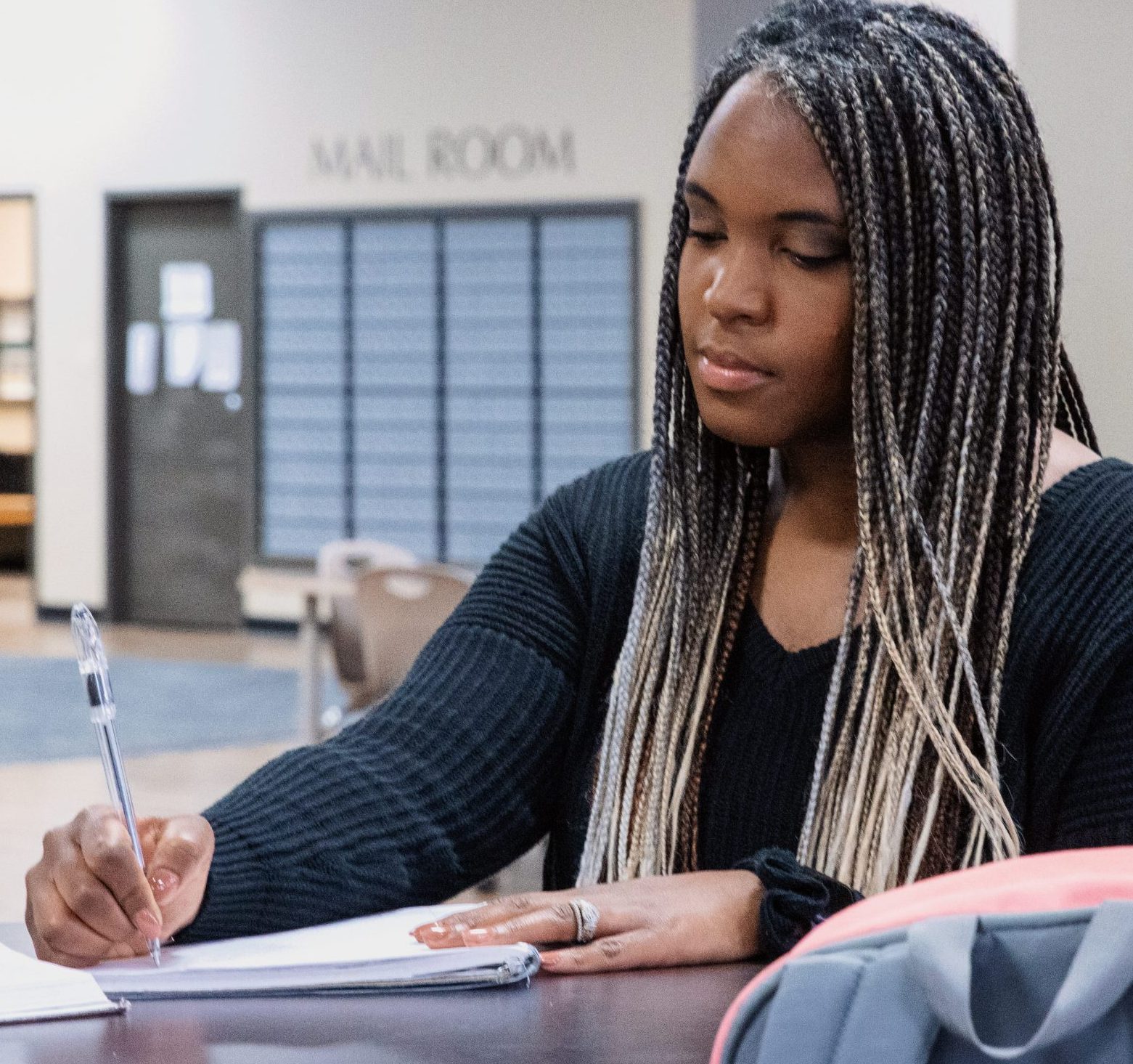 Girl studying by the mail room