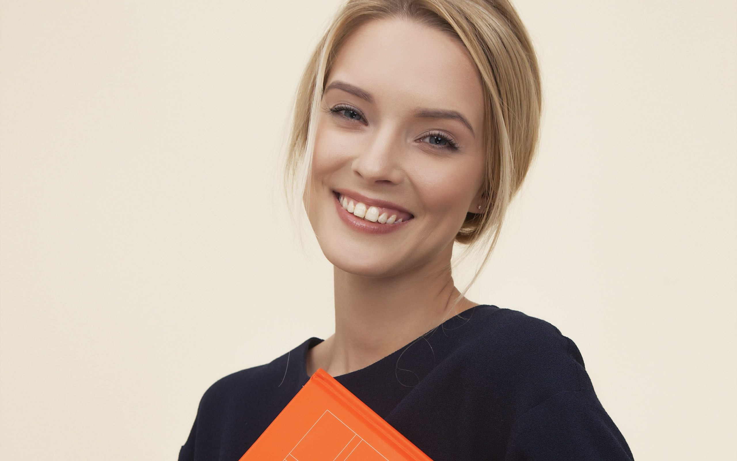 white young woman holding orange folder