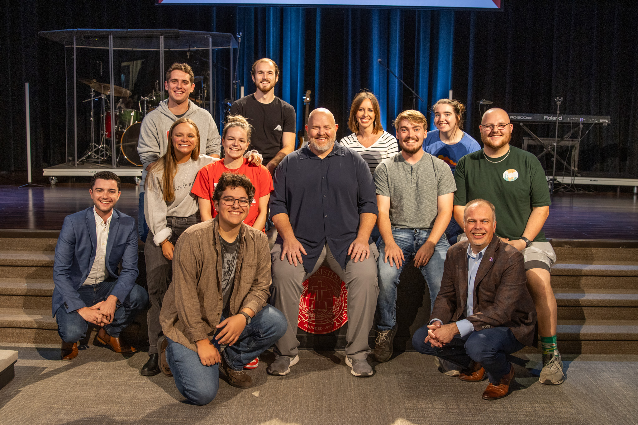 Group photo of MACU students and leaders gathered on stage, showcasing the vibrant community and partnerships that empower future ministry leaders through mentorship and hands-on experiences.
