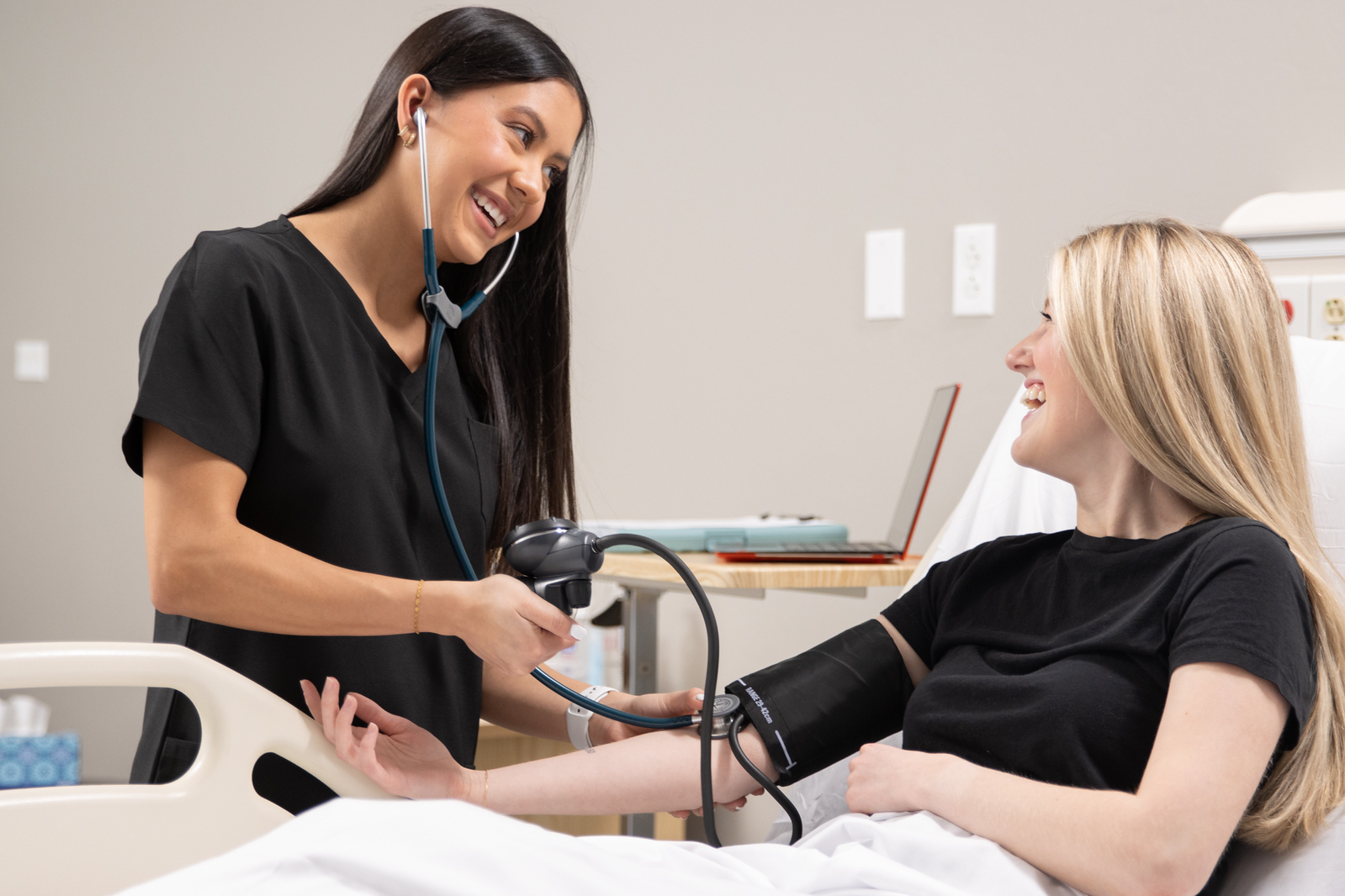 A nurse examines a patient.